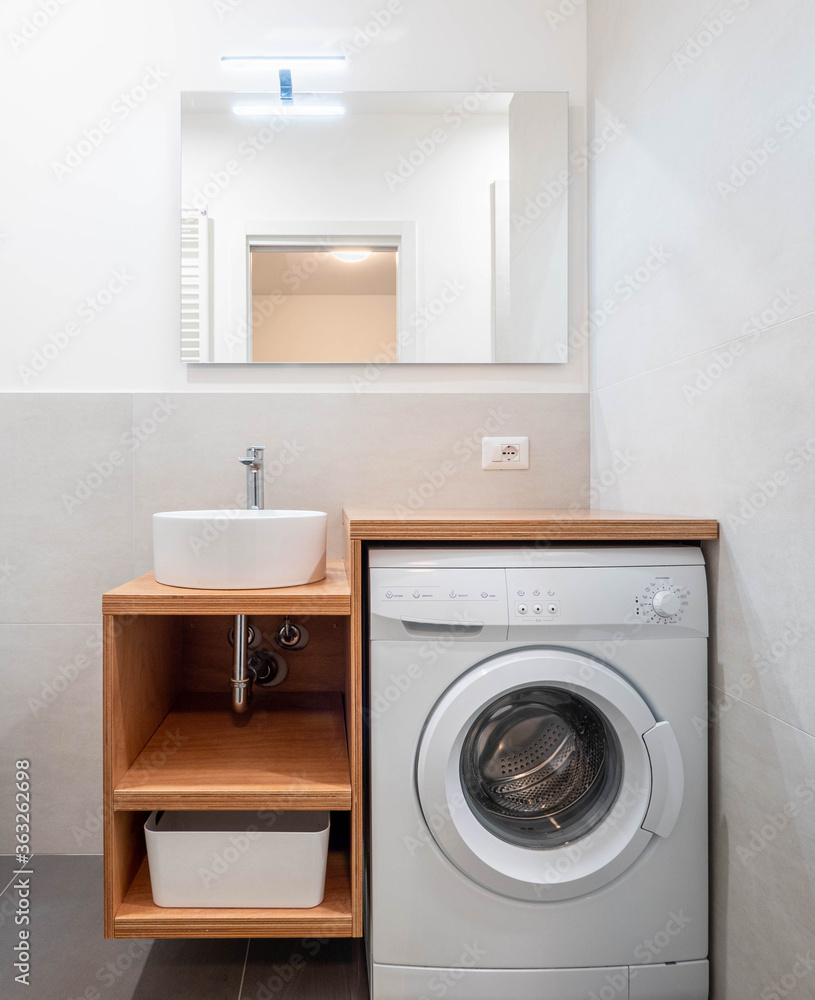 Modern laundry room with washing machine, small bathroom laundry, washing  machine in home Stock Photo | Adobe Stock