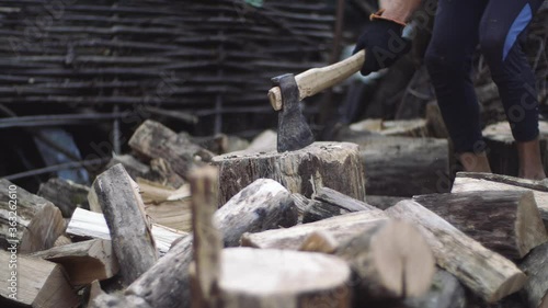 Wallpaper Mural Man cuts tree outdoors in slow motion. Mans hands work with an ax. Lumberjack man chopping tree trunks with ax for firewood. Close-up of hand made touching a felled tree firewood for the winter Torontodigital.ca