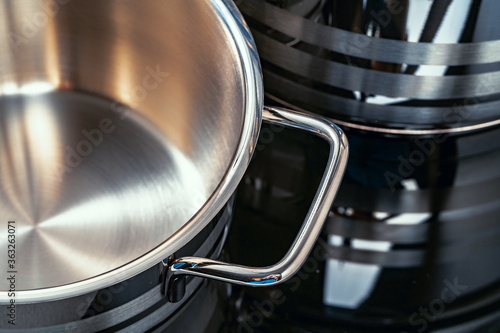 Set of aluminum pans on black surface close up
