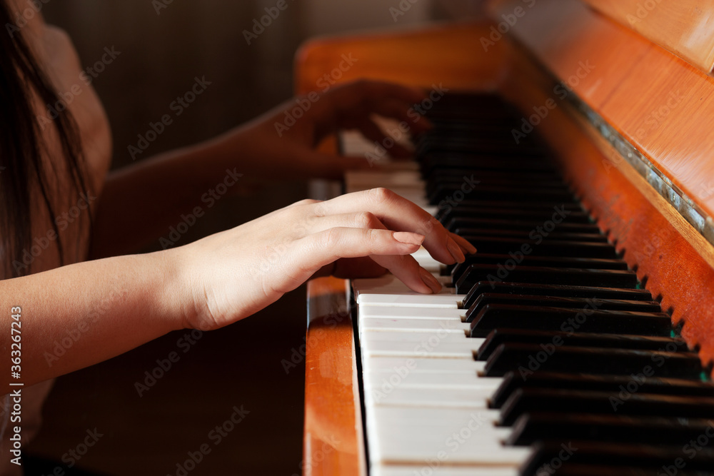 woman plays the piano