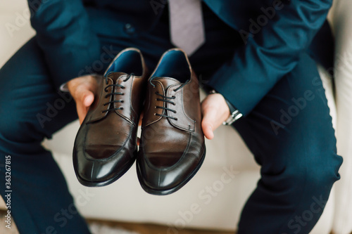 The groom is going to the wedding to the bride in a suit shoes