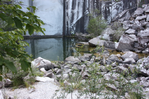 small natural lake inside a marble quarry