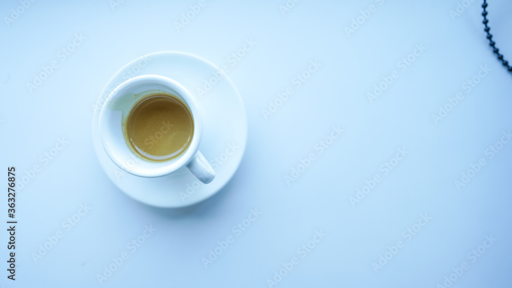 white cup and plate fill with coffee espresso on white table beside window light cool tone top view left side stock photo white cup and plate fill with coffee espresso on white table beside window light cool tone top view left side stock photo