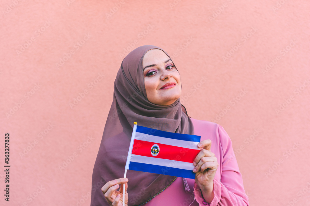 Muslim woman in hijab holds flag of Costa Rica Muslim woman in hijab holds flag of Costa Rica
