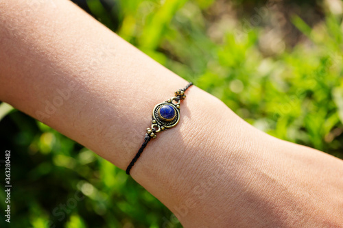 Mineral stone lapis lazuli pendant bead bracelet on female wrist