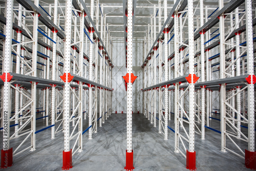 Warehouse Cantilever Racking Systems for storage Aluminum Pipe or profiles. Pallet Rack and Industrial Warehouse Racking. Steel profiles. Interior of Empty Big Huge Warehouse.