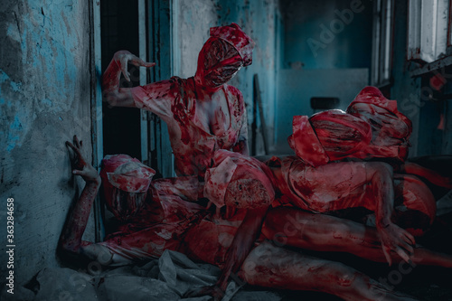 Cosplayers portray bloody monsters mannequins.