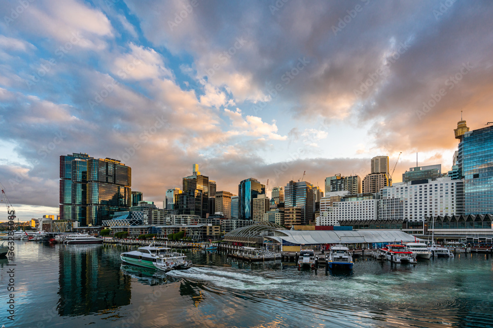 Sydney downtown skyline at Darling Harbor bay, business and recreational arcade, in Sydney, NSW, Australia at sunrise