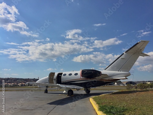 Business jet parked at airport on sunny day waiting for passengers