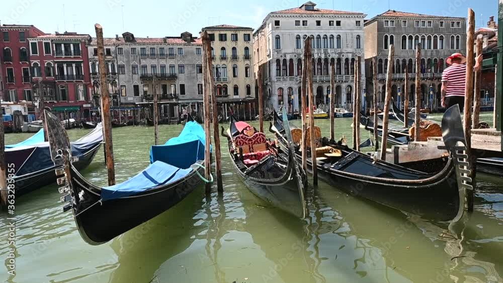 Venice, Italy - gondolas and gondoliers in the Grand Canal near the Rialto Bridge, in the San Marco Basin and between the canals of the lagoon city Venice, Italy - gondolas and gondoliers in the Grand Canal near the Rialto Bridge, in the San Marco Basin and between the canals of the lagoon city