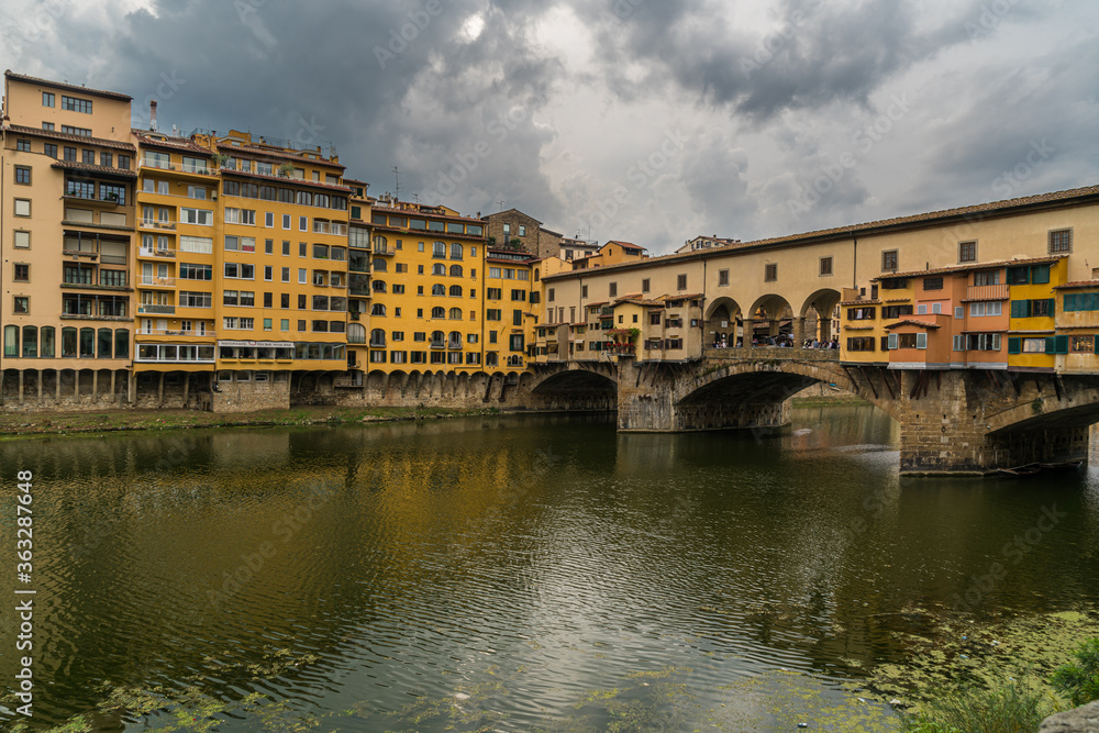 Famous Ponte Vecchio bridge and cityscape view of old town Florence by Arno river in Florence, Italy. Famous Ponte Vecchio bridge and cityscape view of old town Florence by Arno river in Florence, Italy.