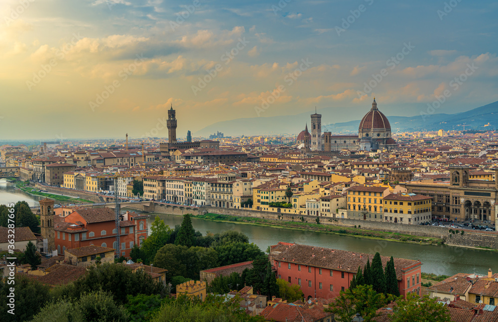 Florence old city skyline at sunset with Ponte Vecchio over Arno River and Cathedral of Santa Maria del Fiore in Florence, Tuscany, Italy.