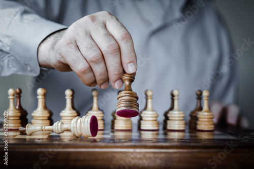 Wallpaper Mural Strategy concept, hand of businessman moving wooden chess figure in play, management or leadership competition success background. Torontodigital.ca