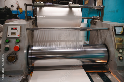 Industrial laminator, lamination of paper products. The manufacture of packaging. Outdated equipment. Company. Place for text.