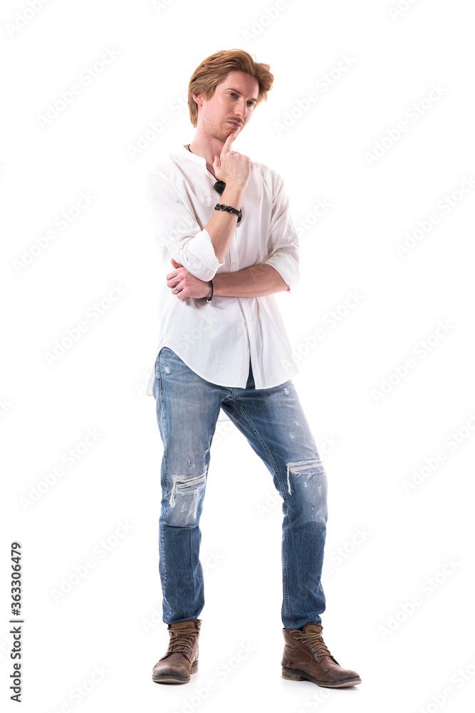 Interested young well dressed man looking away at attention with finger on chin and folded hands. Full body length isolated on white background. Interested young well dressed man looking away at attention with finger on chin and folded hands. Full body length isolated on white background.