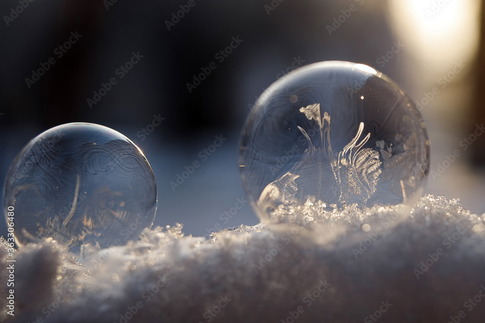 Frozen soap ball. Frozen soap bubble, close up on blurred background Frozen soap ball. Frozen soap bubble, close up on blurred background