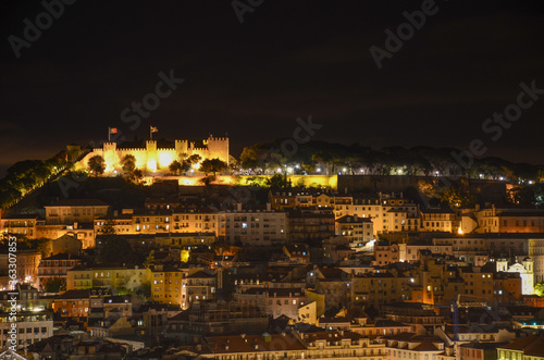 Fototapeta Naklejka Na Ścianę i Meble -  Night view of old town and Sao Jorge Castle from Sao Pedro de Alcantara viewpoint (miradouro), in Lisbon, Portugal