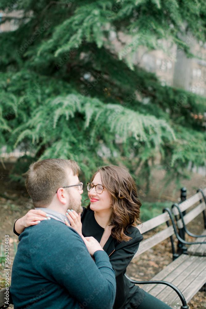 Fototapeta premium A couple in love having a romantic moment and showing mutual affection in a local urban park outdoors