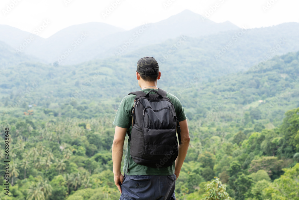 Asian Traveler with Backpack  Look through the Forest