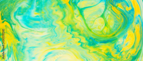Fluid Art. Abstract blurred colorful background. Swirl liquid pattern. Marble effect of green color. Trendy colorful backdrop