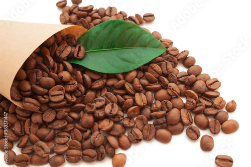 coffee beans in a cornet with green leaf on white background