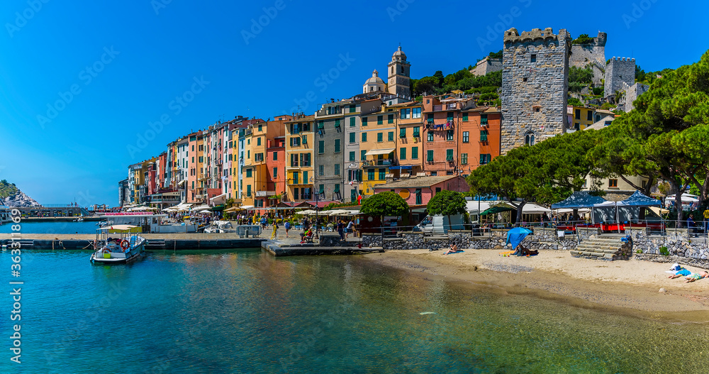 The beach in Porto Venere, Italy back by the colouful houses on the waterfront in the summertime