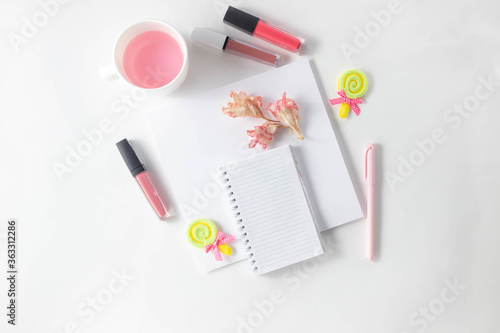 Female workspace with empty open notebook for writing, pen on a white table. Top view, flat lay, copy space, minimalism