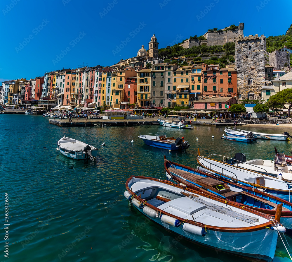 Sunshine highlights the multi-coloured buildings of the old town of Porto Venere, Italy in the summertime
