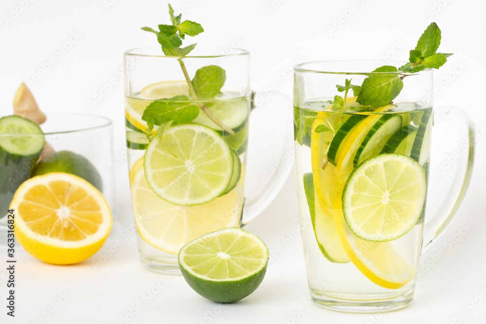 Detox water with lemon, lime, ginger, cucumber and mint in a transparent glass. Healthy lifestyle, proper nutrition. Detox water with lemon, lime, ginger, cucumber and mint in a transparent glass. Healthy lifestyle, proper nutrition.