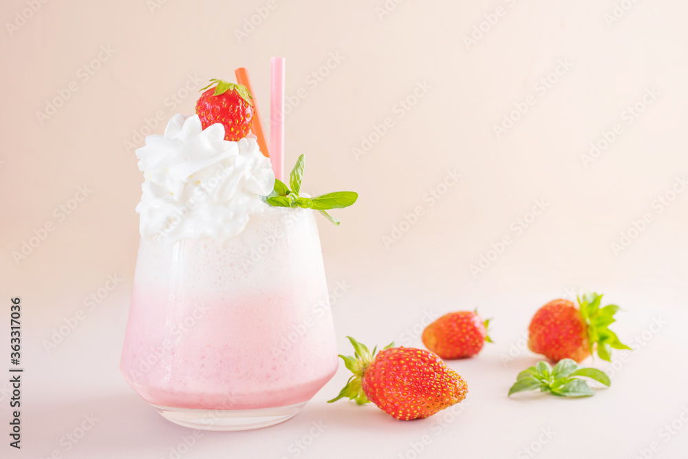 Strawberry milkshake on a light background in a transparent glass. Around - strawberries. The concept of delicious fresh drinks, healthy food for breakfast and snack. Strawberry milkshake on a light background in a transparent glass. Around - strawberries. The concept of delicious fresh drinks, healthy food for breakfast and snack.