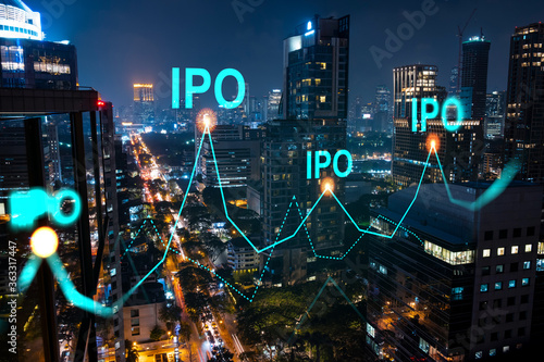 Initial public offering hologram, night panoramic city view of Bangkok. The financial center for multinational corporations in Asia. The concept of boosting the growth by IPO process. Double exposure.