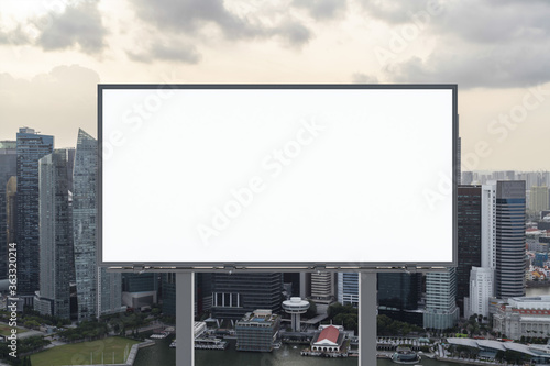 Canvas Print Blank white road billboard with Singapore cityscape background at sunset
