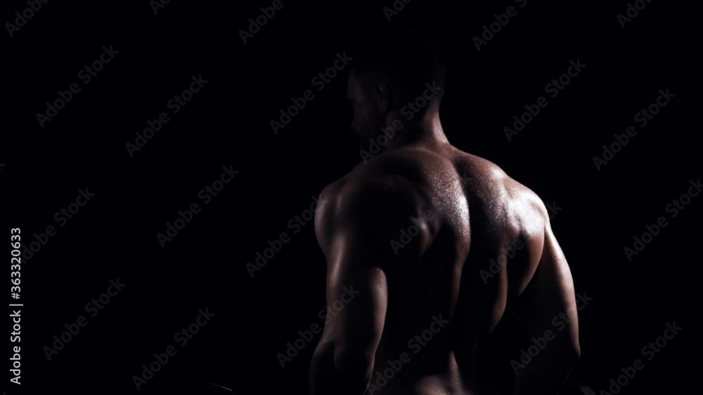 Fit and sporty bodybuilder over black background. Bodybuilder training using barbell. Sport and fitness. Fit and sporty bodybuilder over black background. Bodybuilder training using barbell. Sport and fitness.