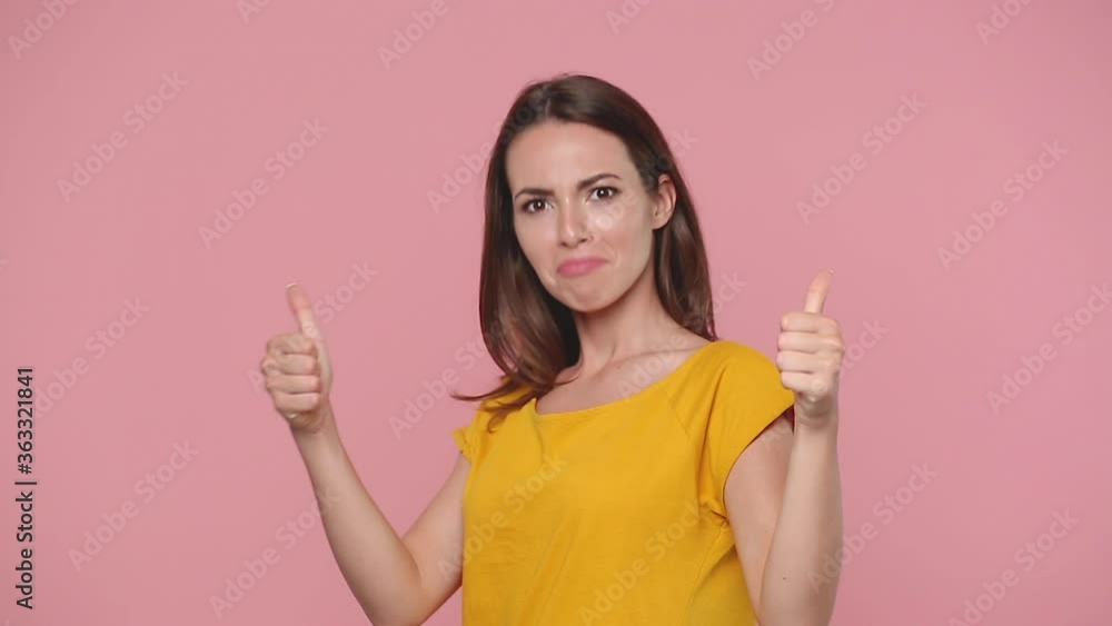 Side profile view smiling young woman in yellow t-shirt posing isolated on pastel pink background studio. People lifestyle concept. Look camera turn round surprised shocked say wow put hands on face Side profile view smiling young woman in yellow t-shirt posing isolated on pastel pink background studio. People lifestyle concept. Look camera turn round surprised shocked say wow put hands on face
