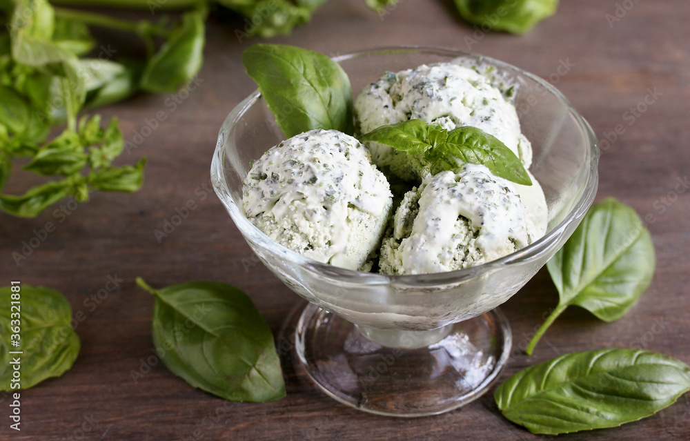 Homemade basil ice cream with fresh basil on a dark background. Copy space Homemade basil ice cream with fresh basil on a dark background. Copy space