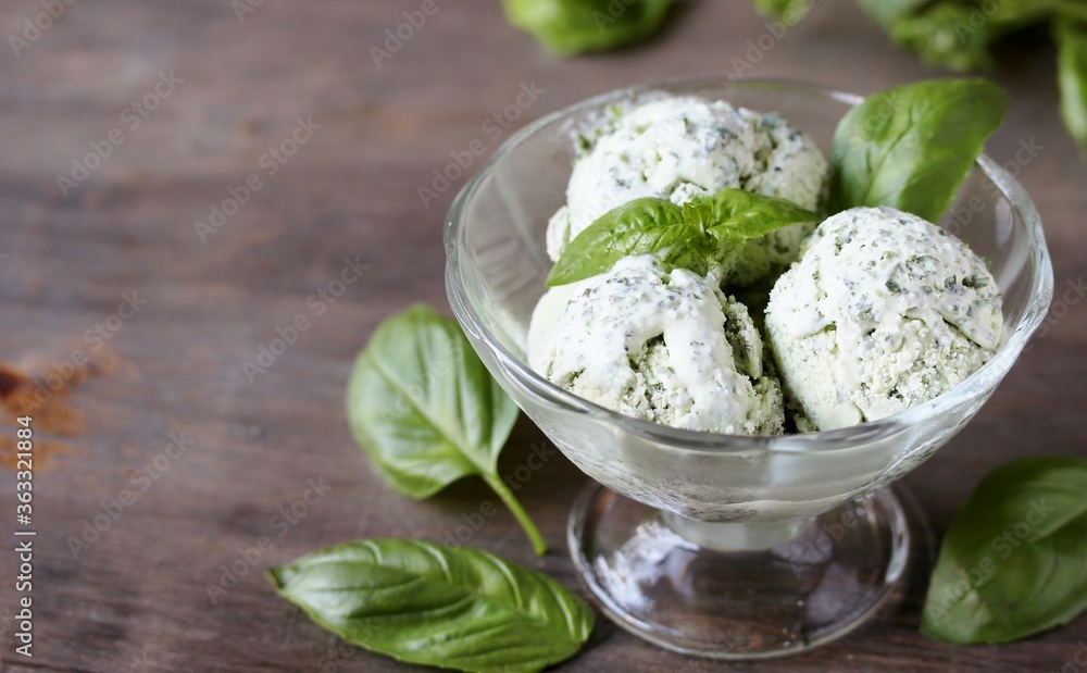 Homemade basil ice cream with fresh basil on a dark background. Copy space Homemade basil ice cream with fresh basil on a dark background. Copy space