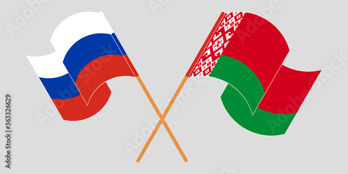 Crossed and waving flags of Belarus and Russia