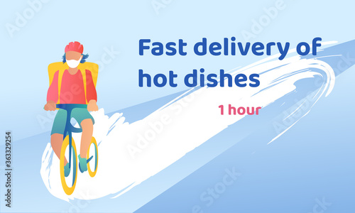 A young guy in a helmet on a bicycle rides fast with delivery. The courier quickly drives a home order.