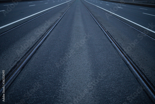 a symmetrical road with rails extending far beyond the horizon