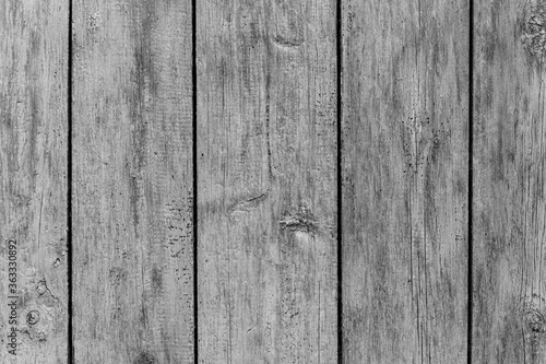 Rustic wood texture or background with scratched paint.  Monochrome.