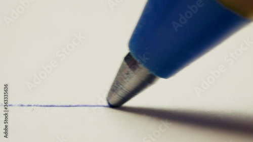 Graphite pencil draws a straight line on a white background paper, macro shot photo