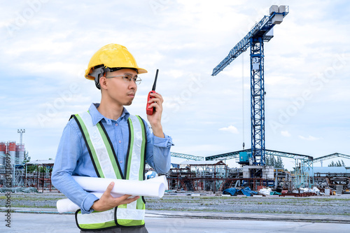 Construction engineers are using the radio at the construction site or building of tall buildings by surveying to make the layout.