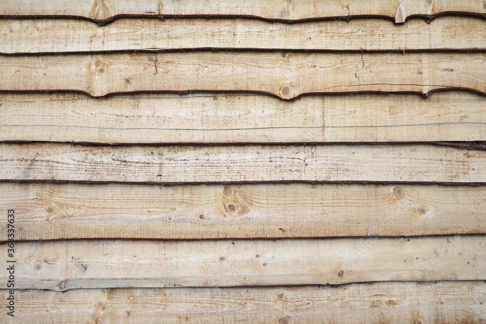 a wall of unpaved boards background. a wall of unpaved boards background.