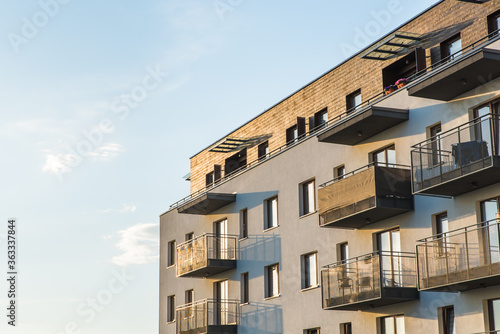Fototapeta Exterior of modern residential apartment building with balconies on housing estate