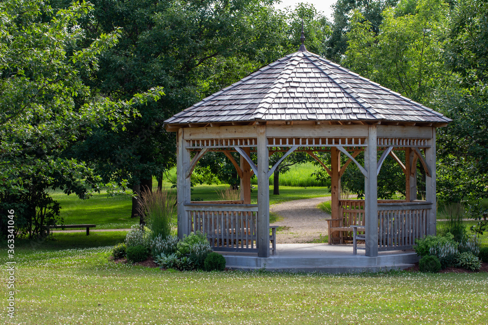Scenic rural tree lined landscape with wooden gazebo