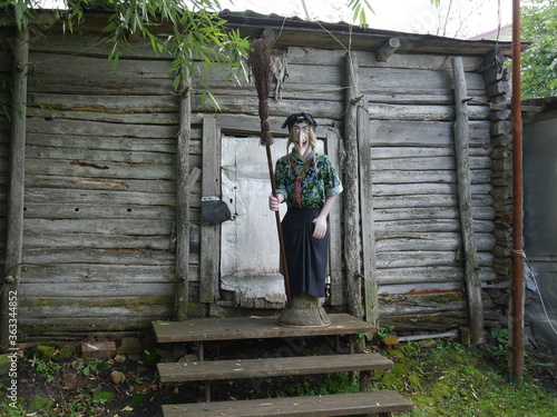 Baba Yaga stands next to the hut house