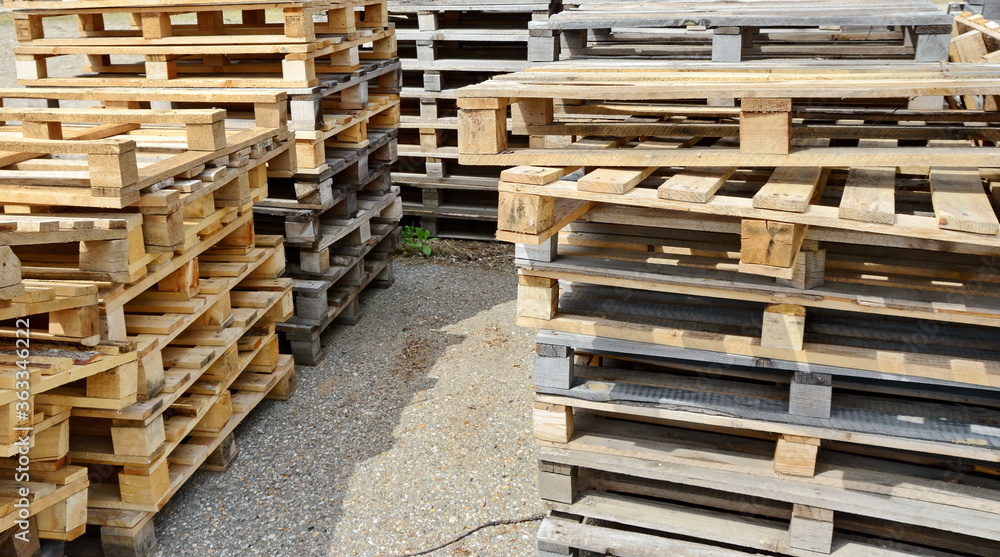 stacked wooden pallets. Wooden production pallets stand piled in a pile. Close-up. stacked wooden pallets. Wooden production pallets stand piled in a pile. Close-up.