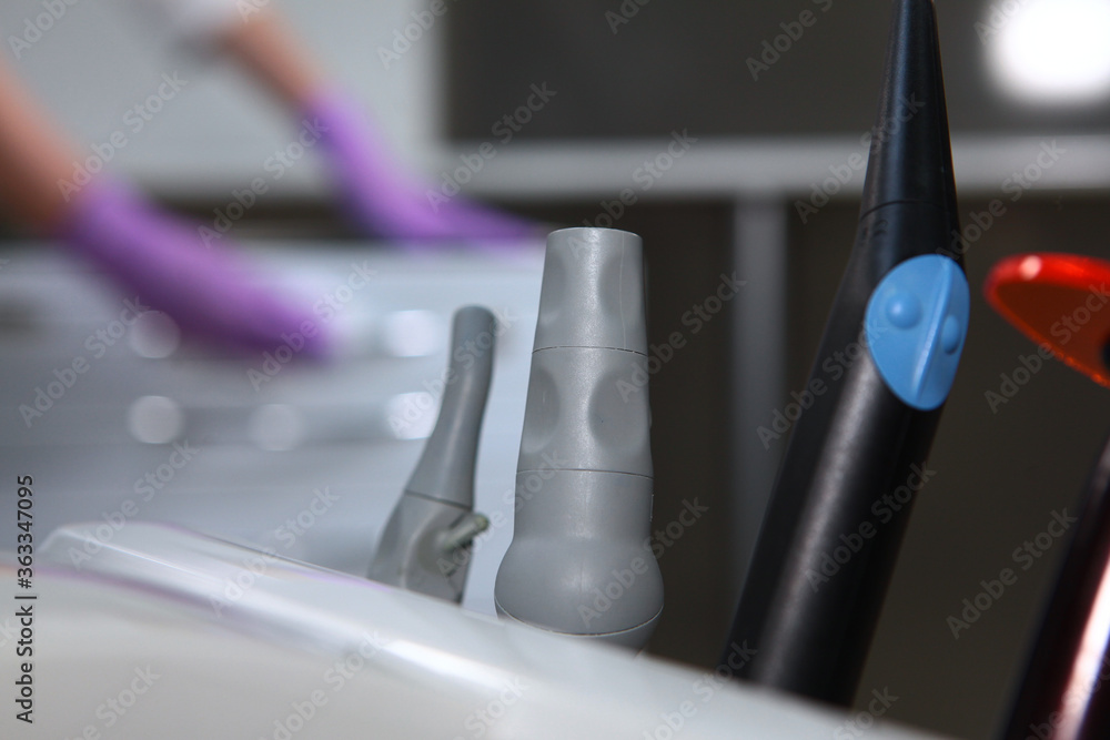 Dental instruments close-up against the background of room disinfection. Out of focus. Unrecognizable photo. Copy of the space. Dental instruments close-up against the background of room disinfection. Out of focus. Unrecognizable photo. Copy of the space.