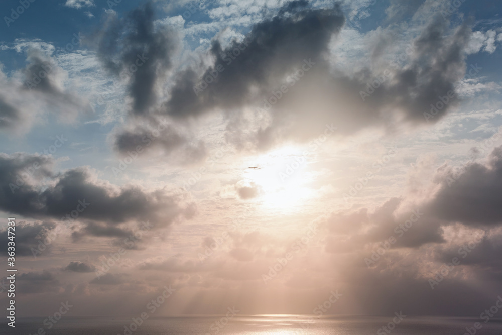 Beautiful sky with sun rays shining through the clouds over the Arabian Sea