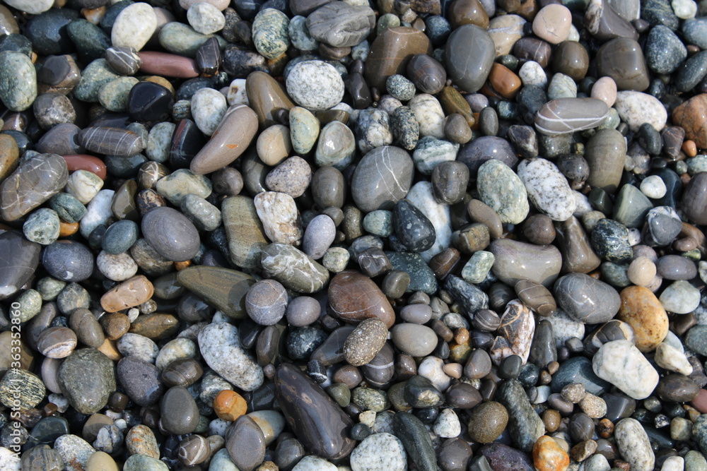 Grey black white brown pebbles stones on the beach background Grey black white brown pebbles stones on the beach background